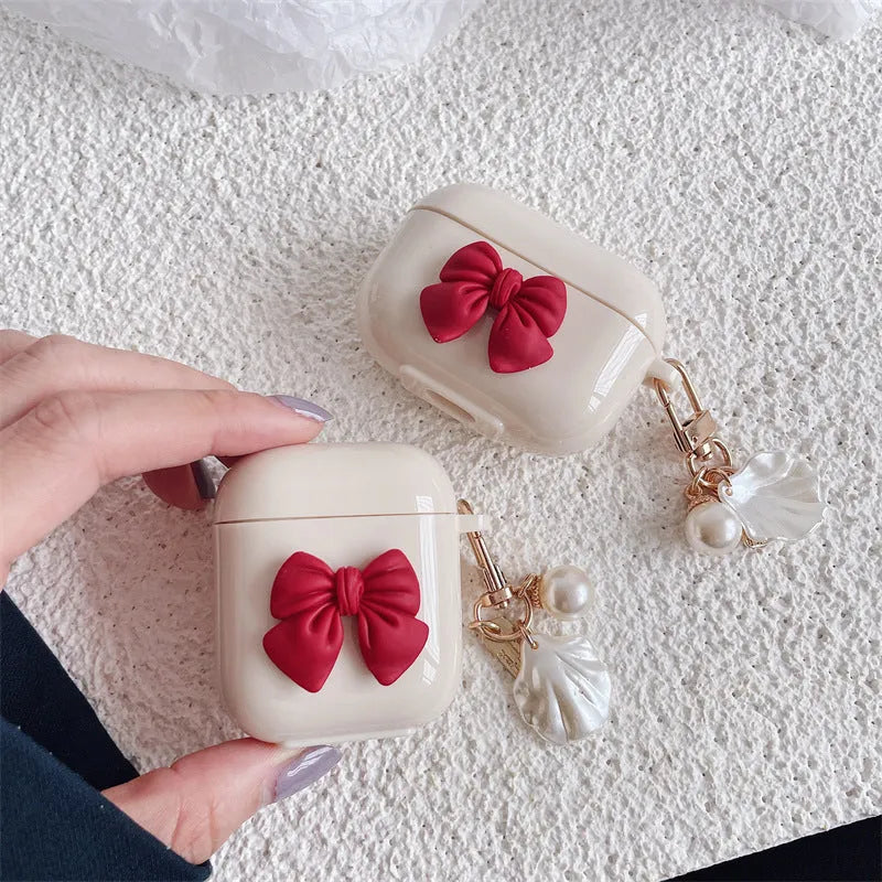 Beige red bow shell TPU AirPods case with clamshell opening design
