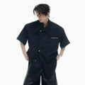 Men's loose fit casual short-sleeved shirt in black with splicing details and metal buttons
