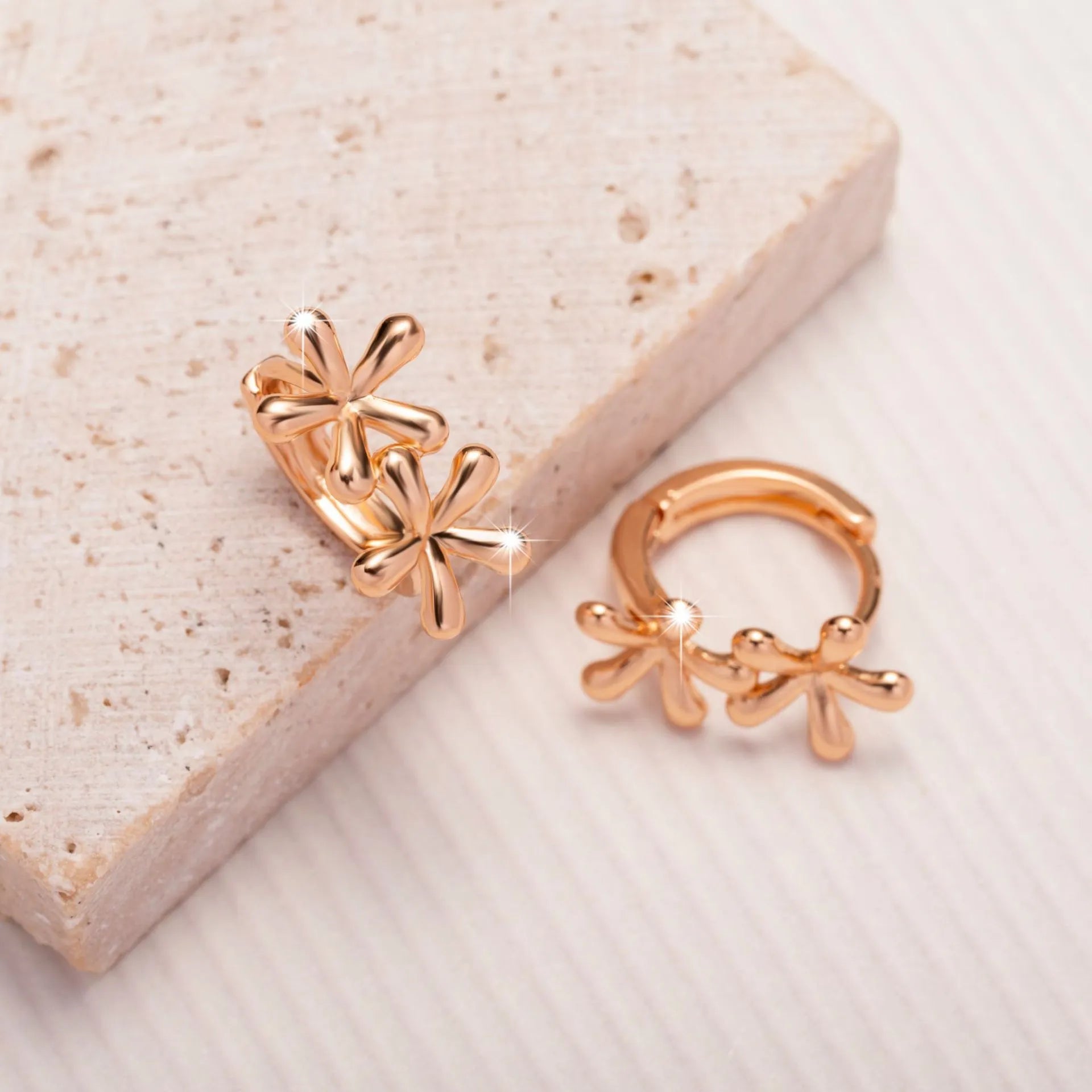 Rose gold circular earrings with waterdrop flower design and electroplated finish