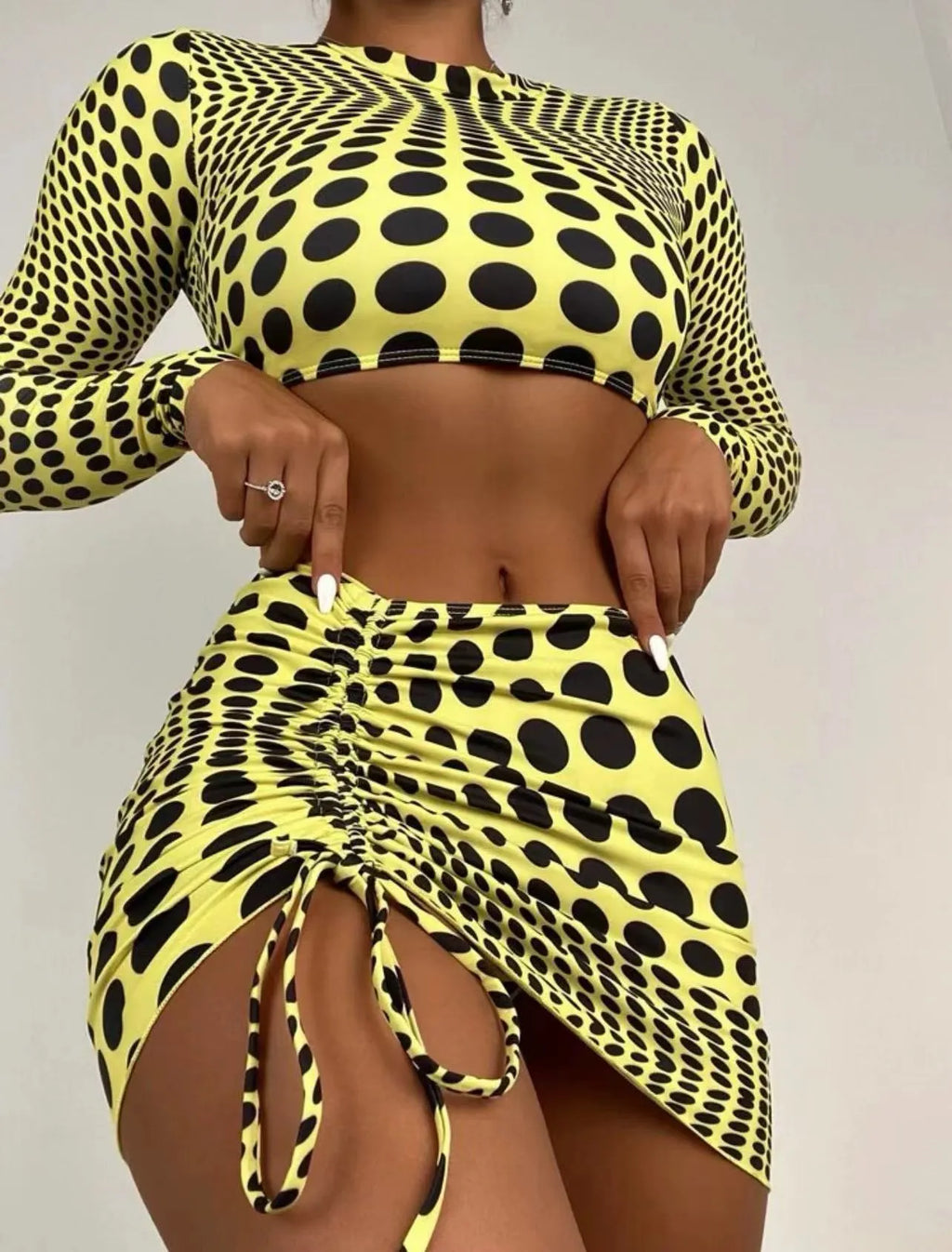 Green and yellow polka dot women's swimsuit three-piece set including top, skirt, and bra.