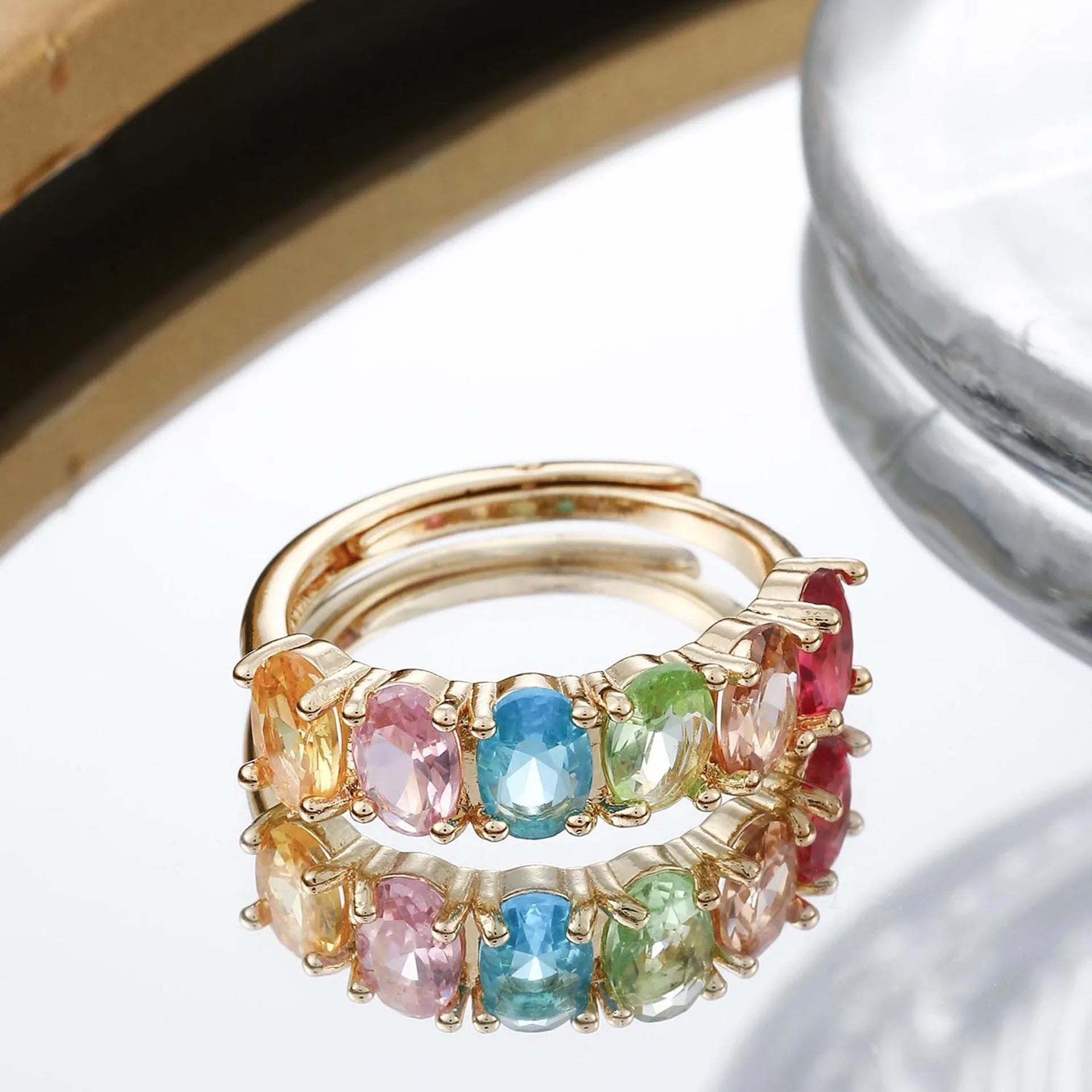 Gold-colour adjustable zircon ring with a simple retro design on a copper band.