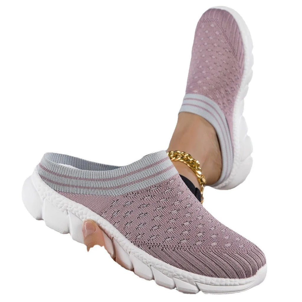 Women's black Flyknit slipper sock with striped pattern and hollowed-out design on a solid background.