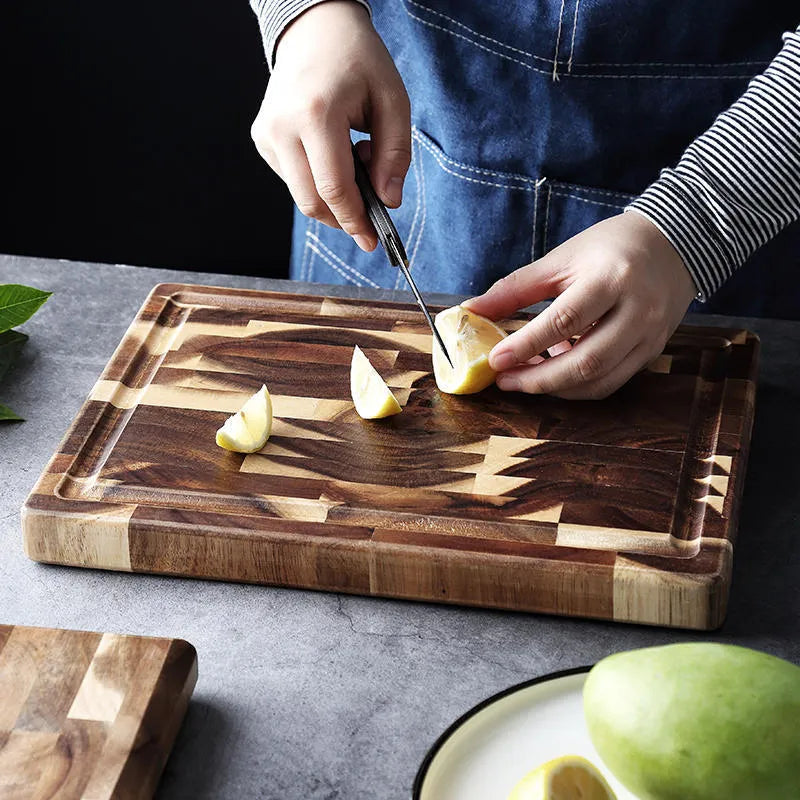 Brown acacia solid wood parquet cutting board with 3cm thickness on a kitchen counter.