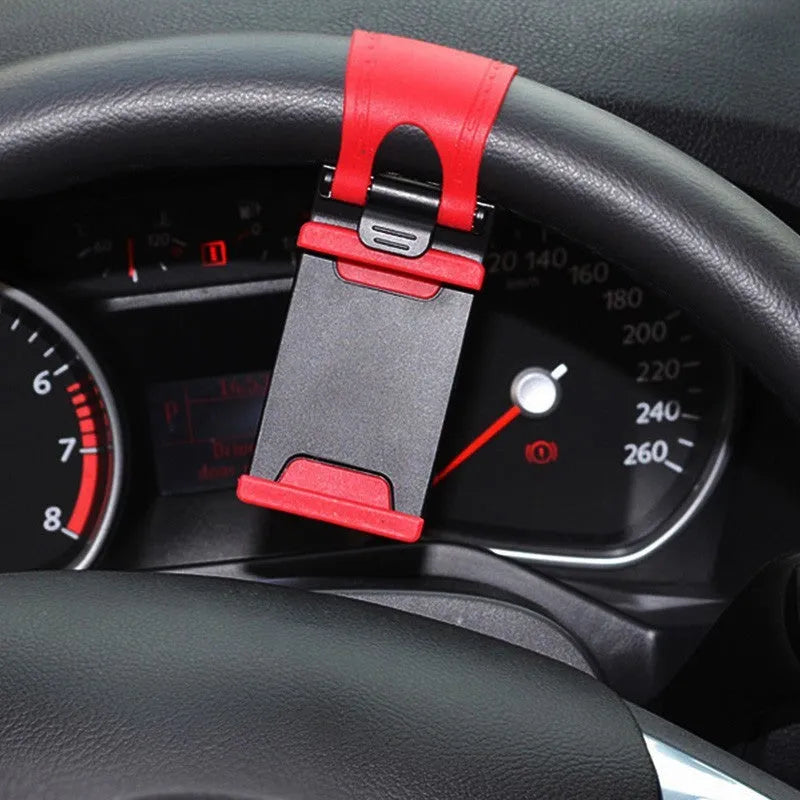 Black steering wheel phone mount holder attached to car steering wheel with smartphone displayed