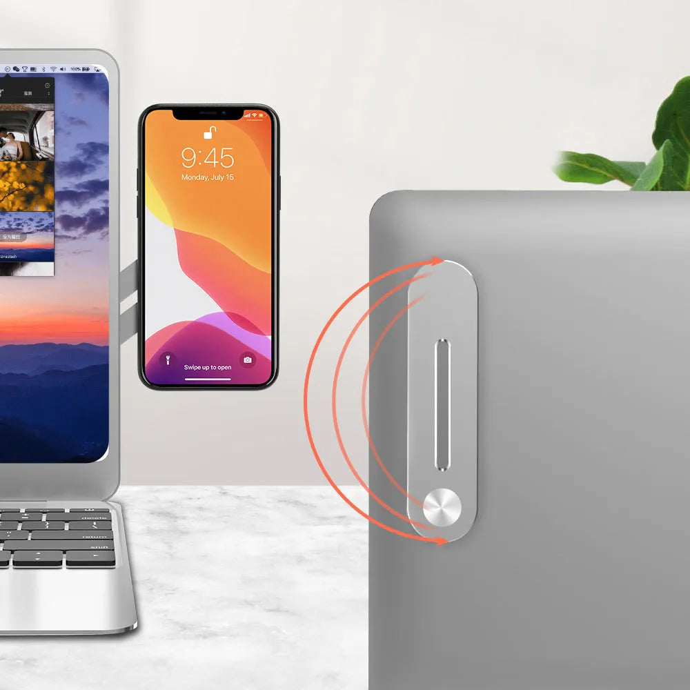 Silver aluminium laptop side mount bracket holding a smartphone beside a laptop screen.