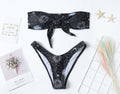 Black one-piece swimsuit with bikini print and backless design for women's swimming and fitness