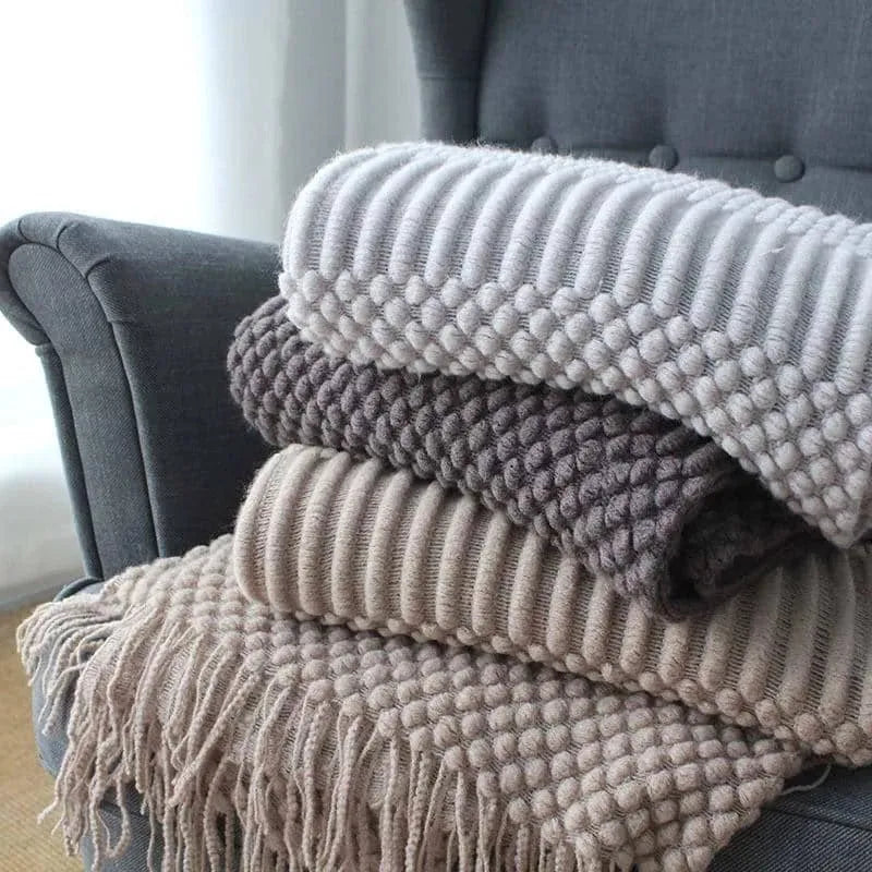 Small light grey polyester nap blanket folded, showing its size of 127 by 170 centimetres.