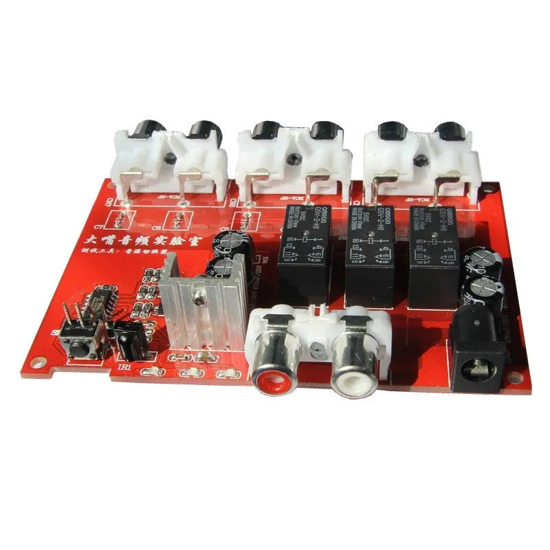 Silver audio source selector switch unit with infrared remote control for routing multiple audio signals.