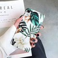 Soft TPU iPhone case with green banana leaf and pink floral art design on a white background.