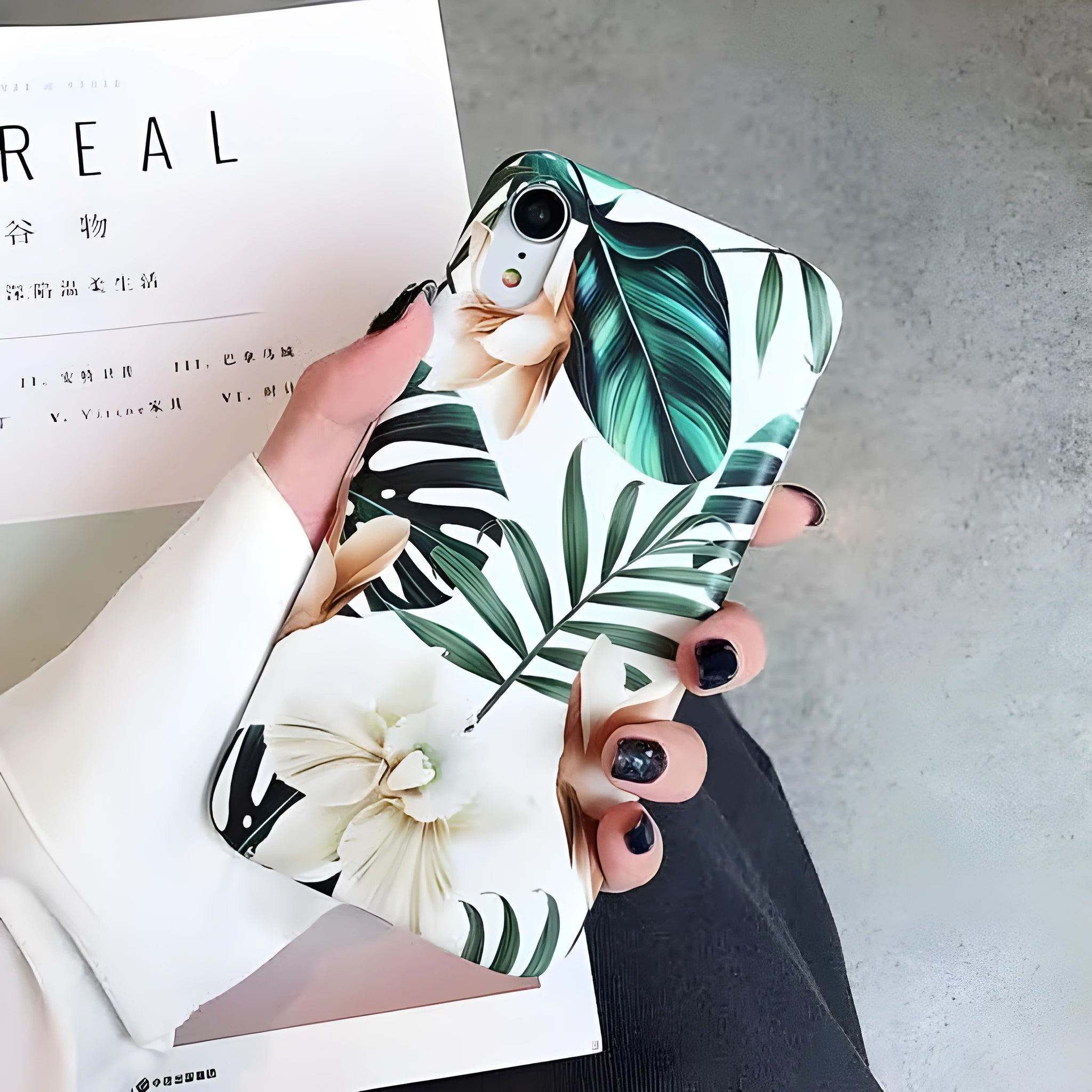 Soft TPU iPhone case with green banana leaf and pink floral art design on a white background.