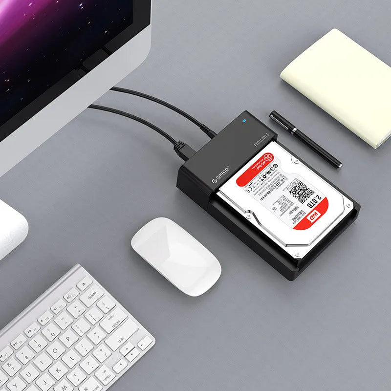 Black plastic 2.5 inch SATA hard disk enclosure with USB cable for portable external storage