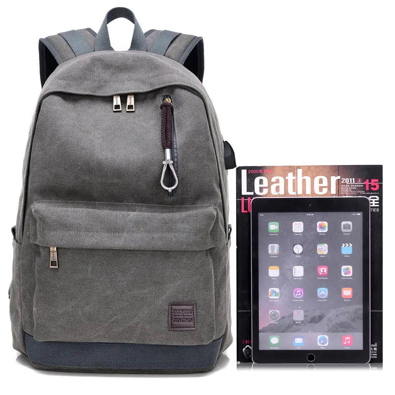 Canvas USB charging backpack in grey colour showing front pockets and shoulder straps