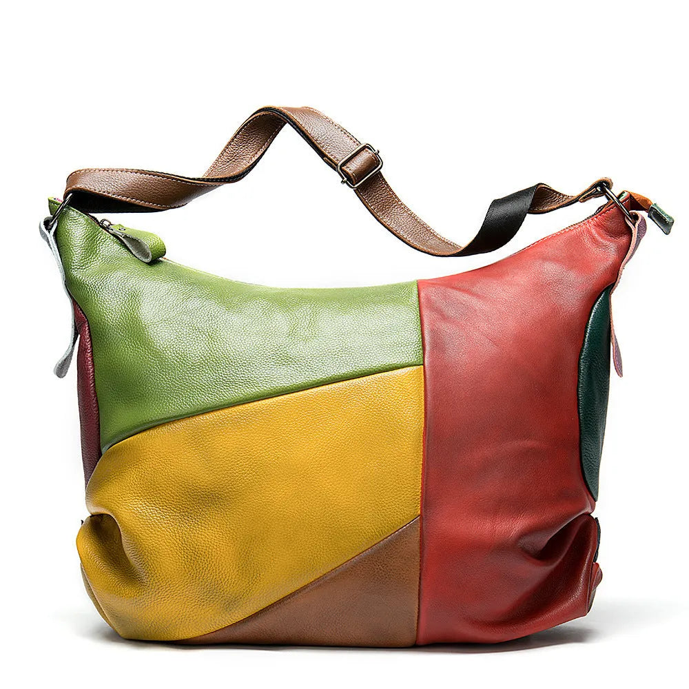 Brown cowhide leather crossbody travel bag showing front flap and adjustable shoulder strap.