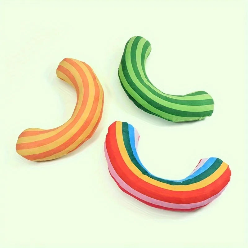 Green, Rainbow, and Yellow cat toy set with noise maker, catnip strip, and striped pillow.
