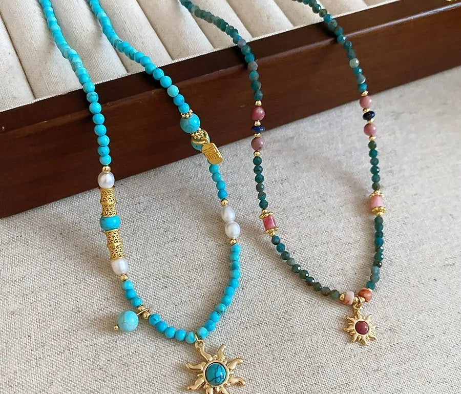 Freshwater pearl necklace with stone sun pendant on clavicle chain