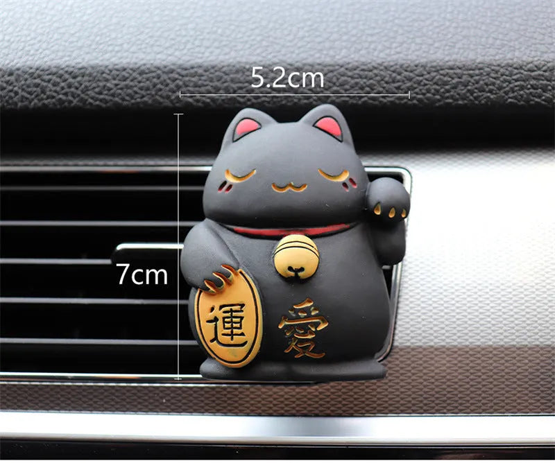 Black and white resin fortune cat decorative clip for car air conditioning vent with aromatherapy function.