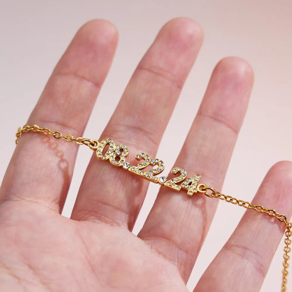 Stainless steel digital bracelet with diamond-set numbers, shown in gold, rose gold, and steel colour options.