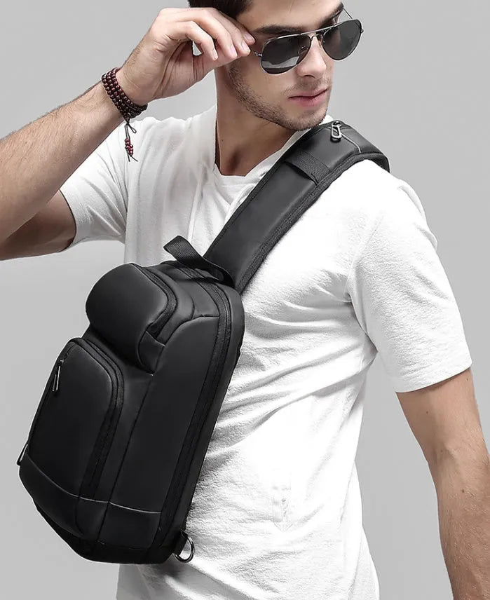 Black medium-sized PVC shoulder bag showing internal organisation pockets and air cushion strap