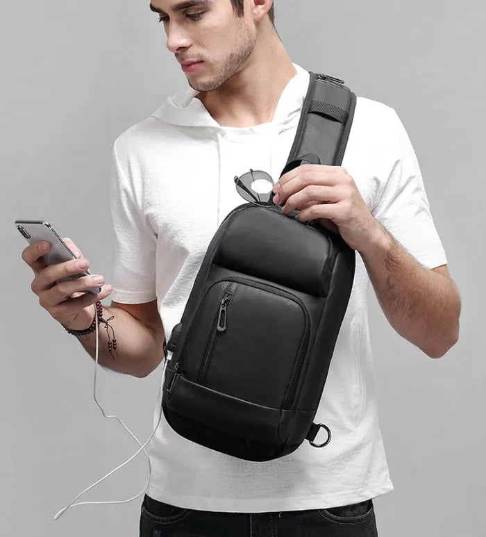 Black medium-sized PVC shoulder bag showing internal organisation pockets and air cushion strap