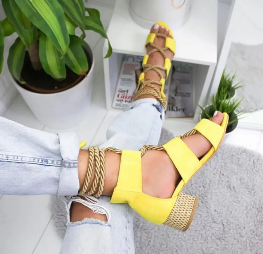 Women's beige suede sandals with thick mid-heel, front strap, and fish-mouth toe.