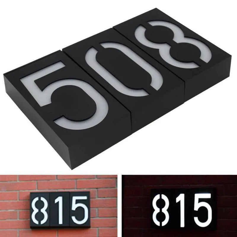 Solar powered illuminated house number light with white LEDs mounted on a wall.