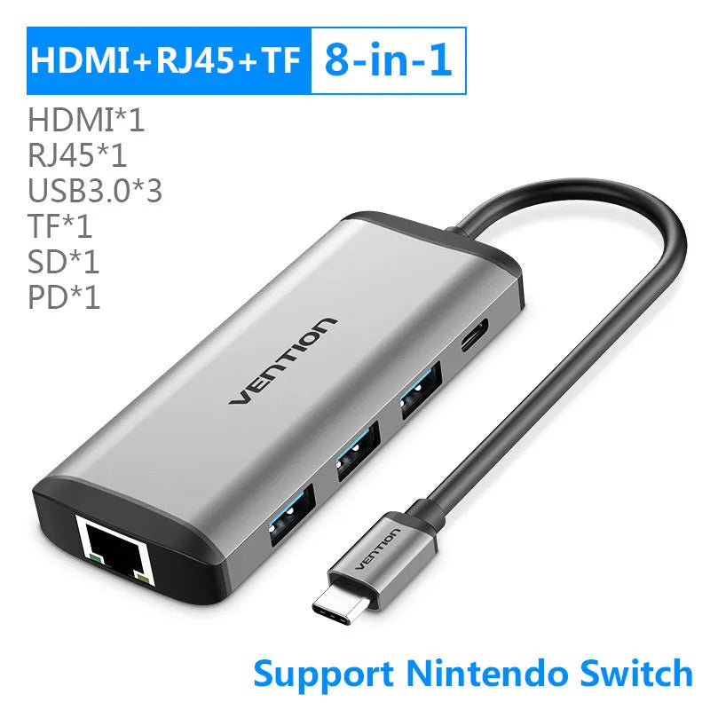 Deep grey Type-C to HDMI, USB 3.0, Ethernet, and card reader hub adapter on a desk