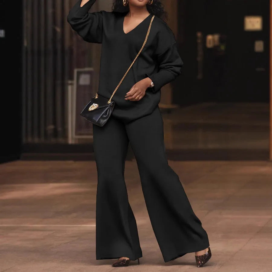 Brown women's long-sleeve suede top and trousers two-piece casual suit on a hanger.