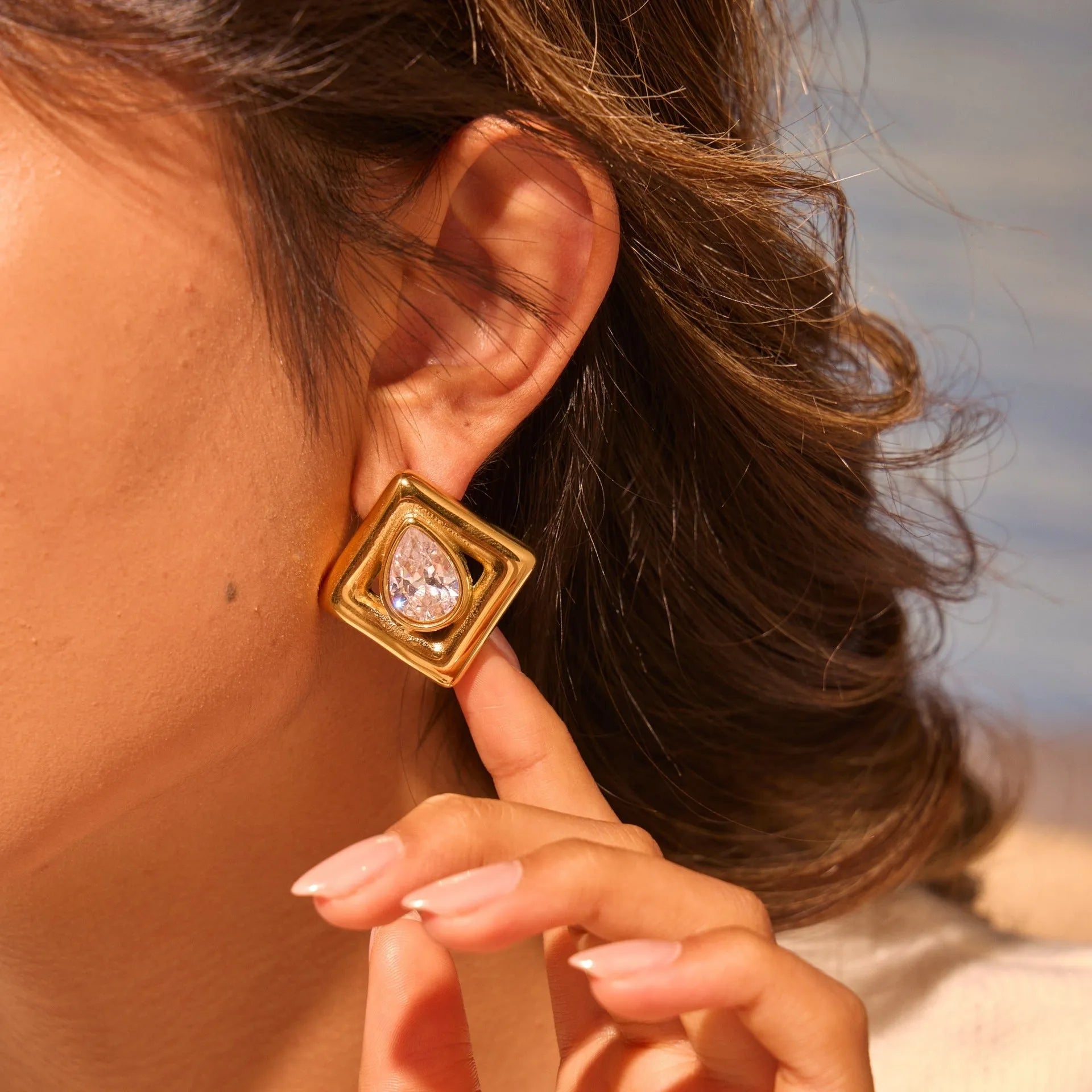 Gold electroplated stainless steel stud earrings with geometric water drop zircon inlay