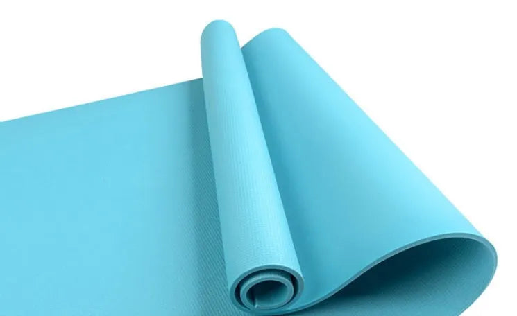 Red EVA fitness yoga mat with 6mm thickness on a wooden floor.