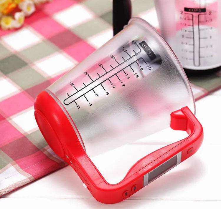 Green electronic kitchen scale measuring cup with LCD display built into handle showing weight measurement