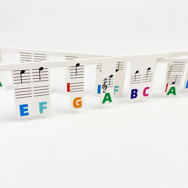 88 key piano note stickers with staff notation and coloured bars on white cardboard