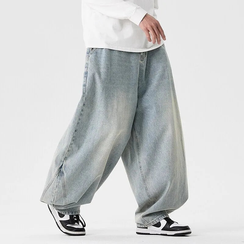 Men's loose fit plus size jeans in dark blue denim showing wide leg and low waist style.
