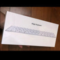 White Apple G6 ultra-thin metal Bluetooth wireless keyboard on a desk.