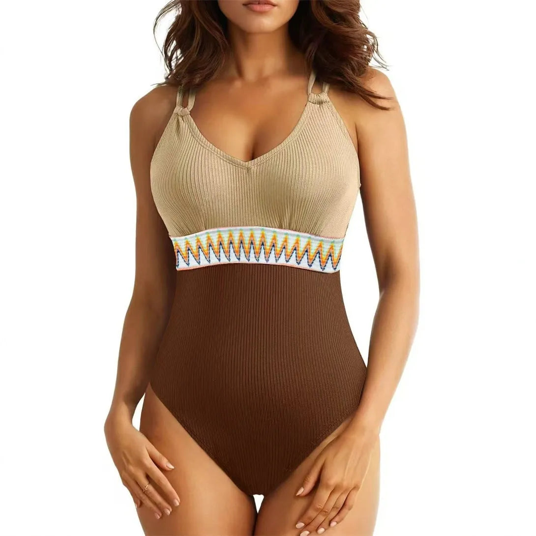Women's one-piece swimsuit in solid colour with rib fabric and panel stitching, available in blue, brown, black and green.