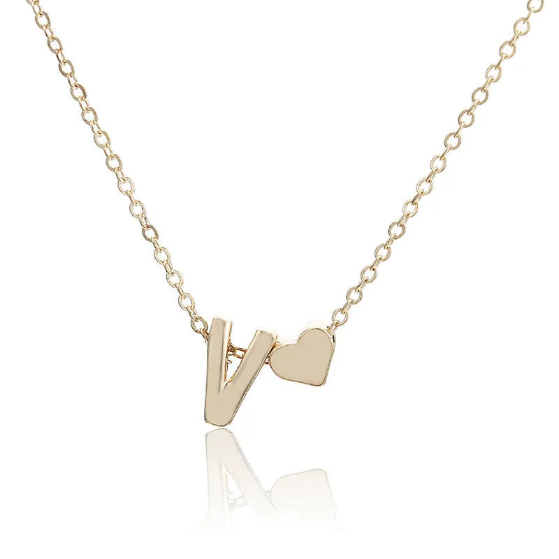 Peach heart shaped letter necklace pendant in gold and silver alloy tones weighing 5.5g