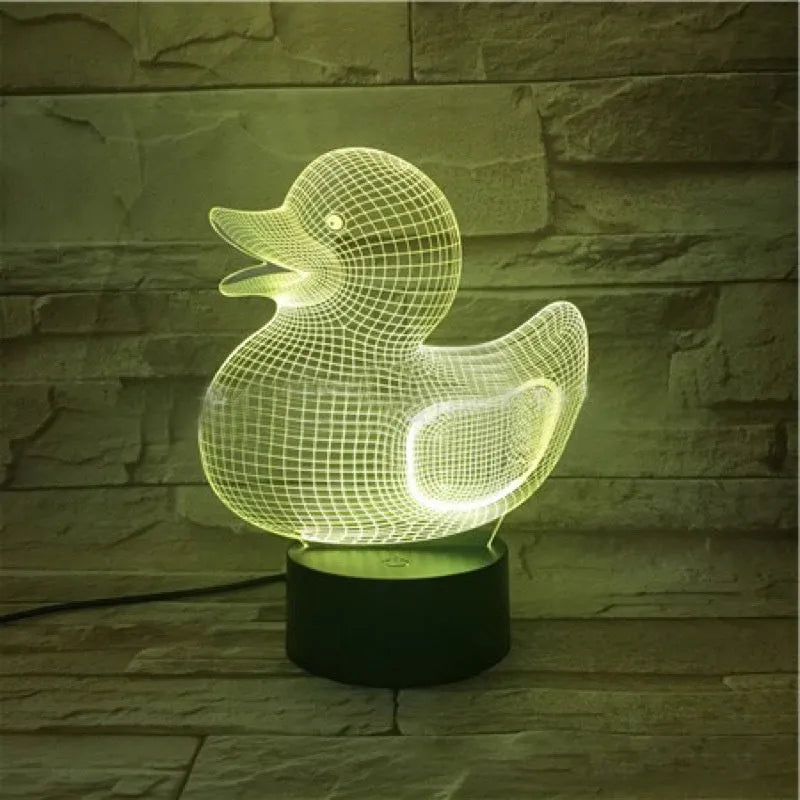 3D little yellow duck night light with colourful LED illumination on a table
