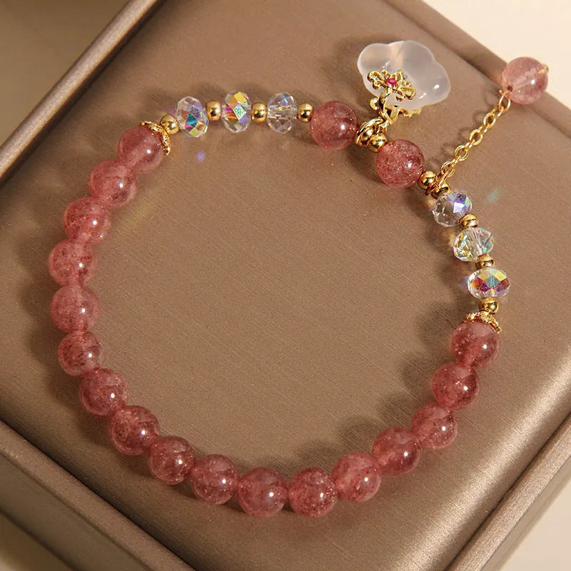 Women's crystal bracelet with strawberry quartz beads and white agate auspicious clouds design
