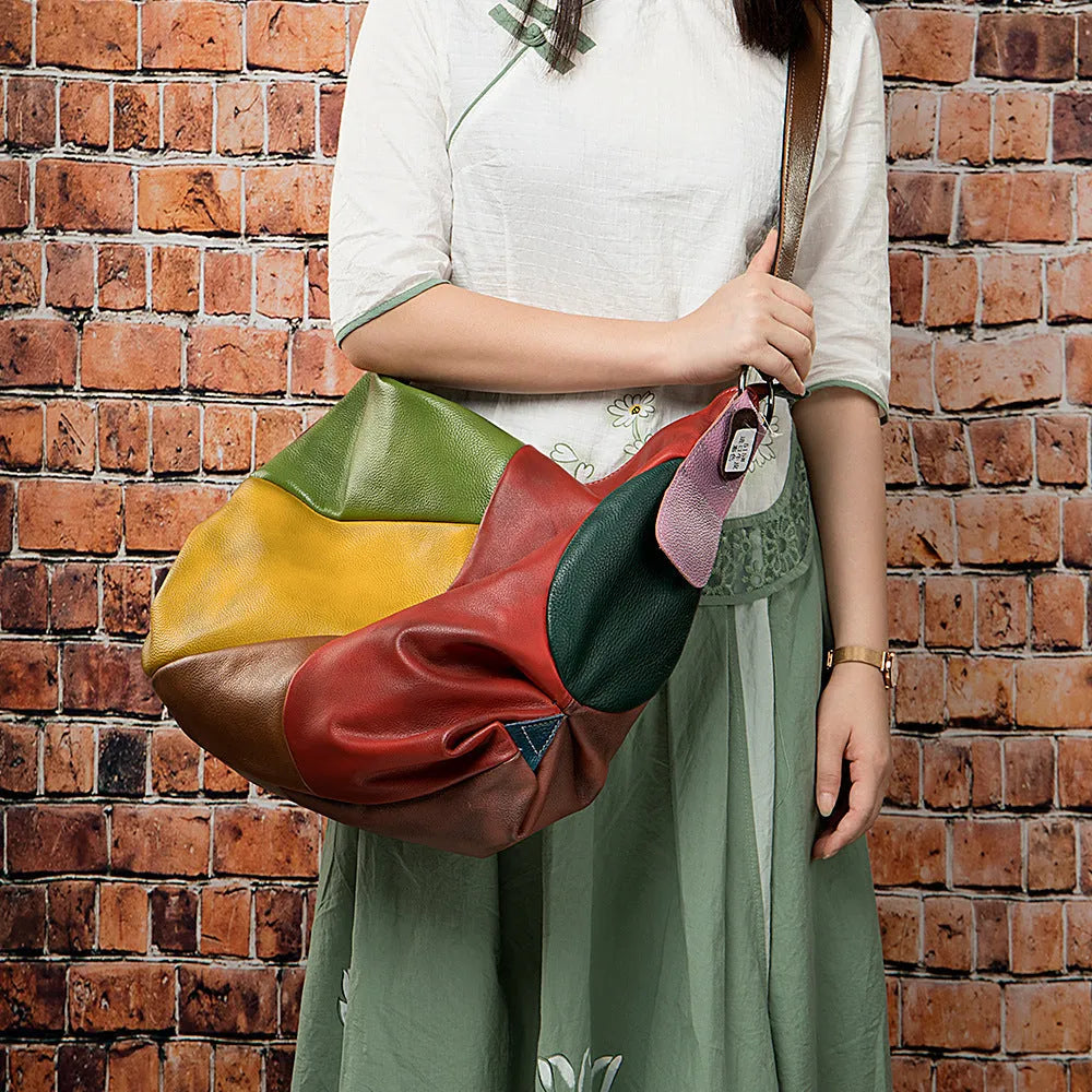 Brown cowhide leather crossbody travel bag showing front flap and adjustable shoulder strap.