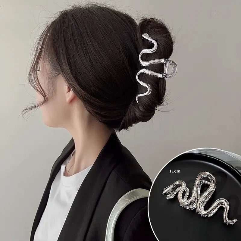 Silver metal hair barrette with a detailed Slytherin snake design, measuring 10.5 cm in length.