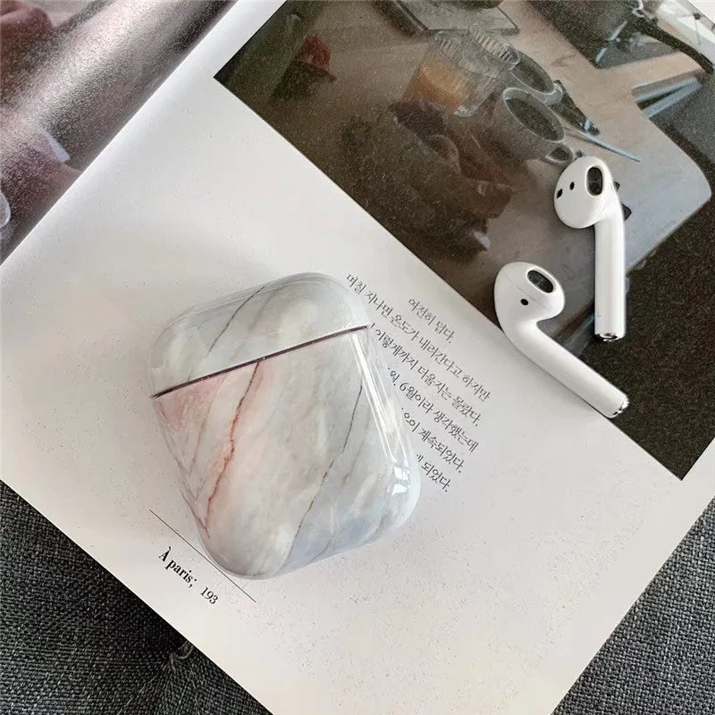 White marble pattern hard case covering an Apple AirPods charging box.