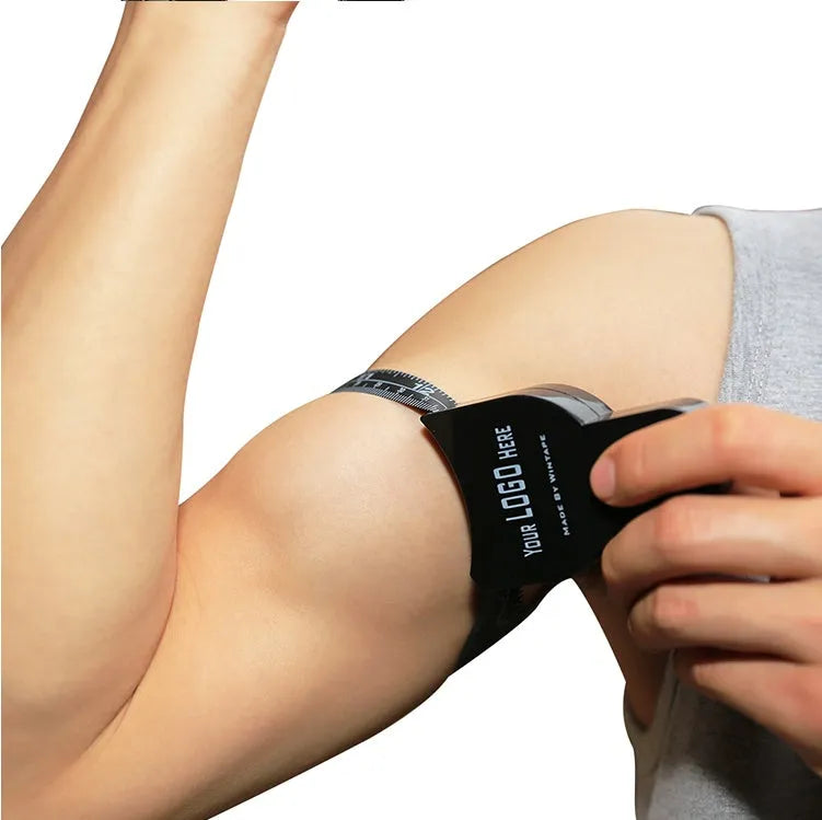 Black ABS body fat caliper with measurement tapes for skin fold thickness analysis