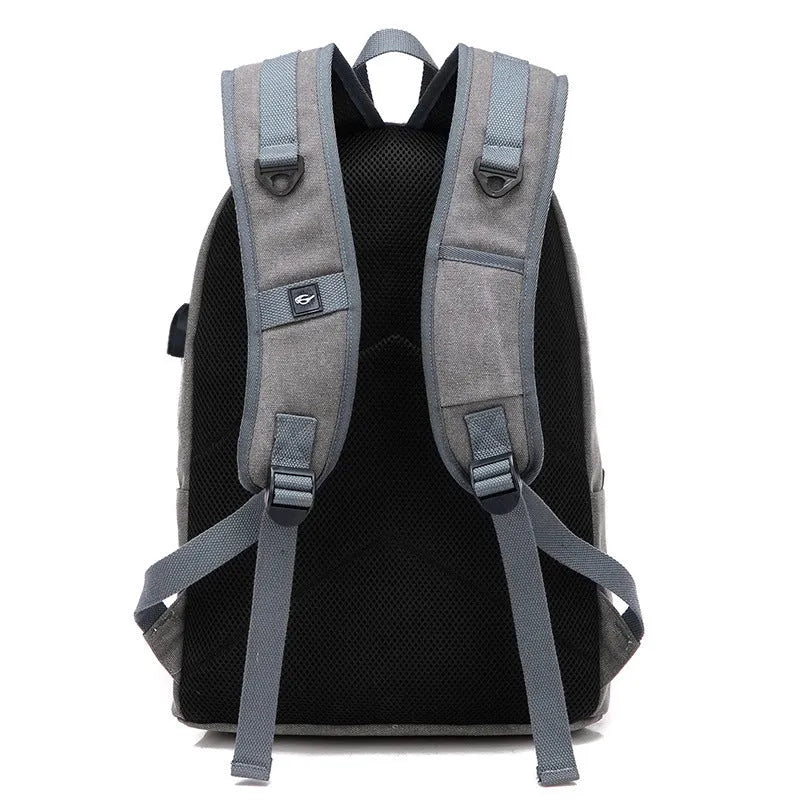 Canvas USB charging backpack in grey colour showing front pockets and shoulder straps