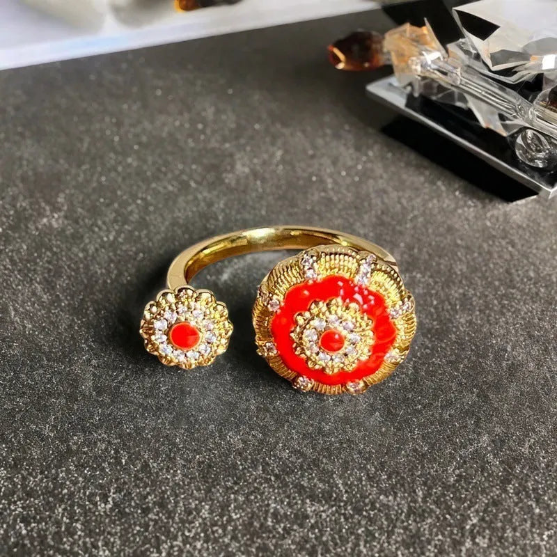 Adjustable copper ring with vintage oil dripping finish showing gourd, flower and bow design with inlaid zircon stones.