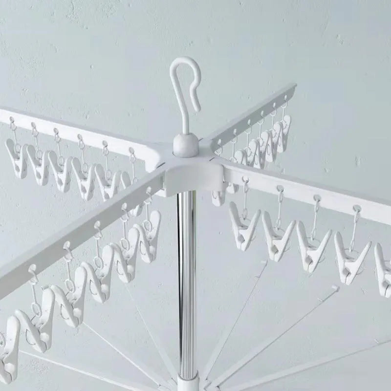 Stainless steel three-layer mobile clothes drying rack with split plastic clips.
