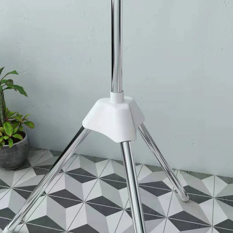 Stainless steel three-layer mobile clothes drying rack with split plastic clips.