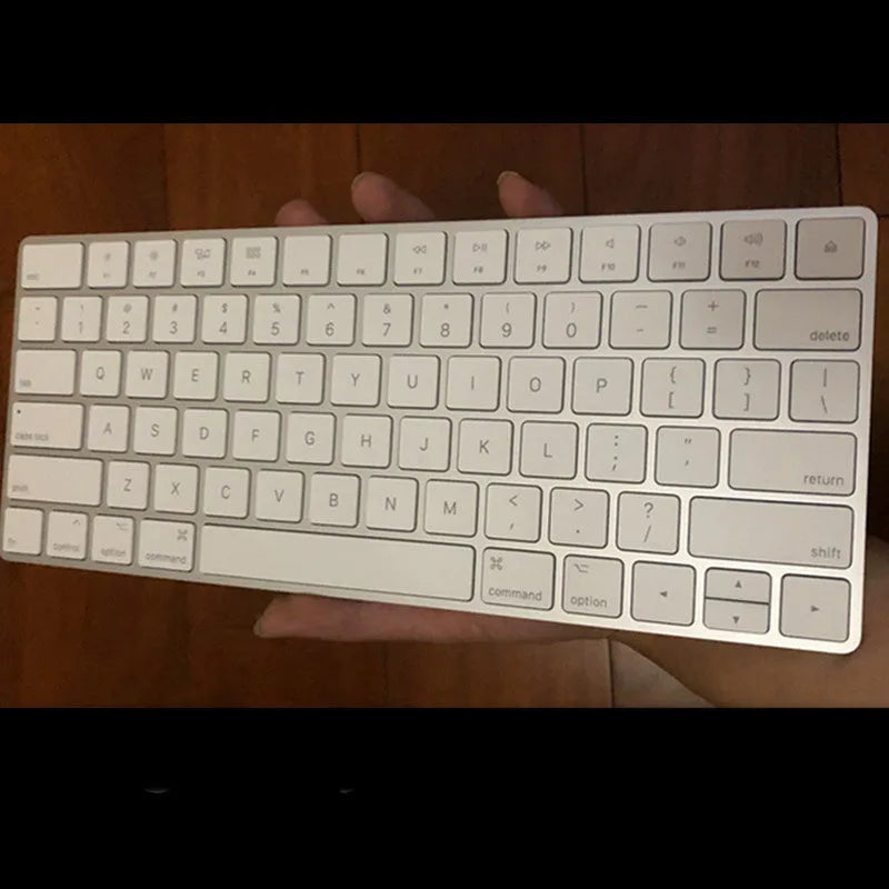White Apple G6 ultra-thin metal Bluetooth wireless keyboard on a desk.