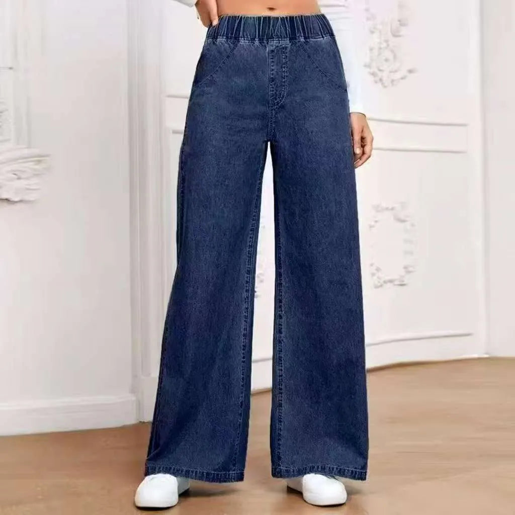 Light blue washed wide-leg denim trousers on a hanger, showing mid-rise waist and straight leg cut.