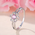 Ladies floral hollow-out fashion ring in white gold powder finish showing detailed openwork pattern