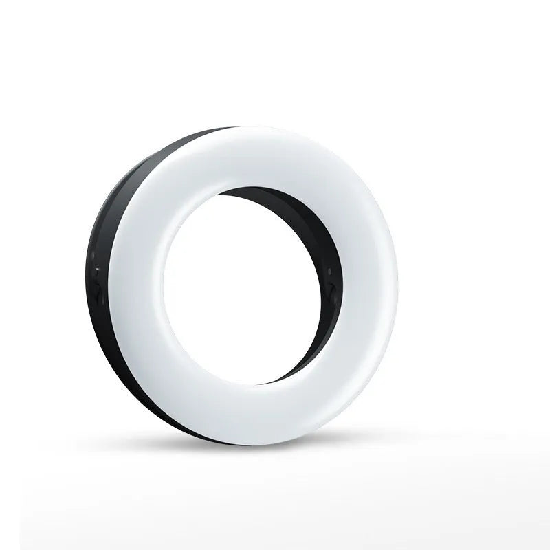 Compact black LED selfie ring light for mobile phones with USB cable.