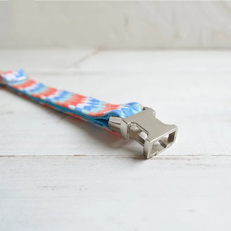 Blue polyester cat collar with printed pattern and lock closure, shown in sizes S and L